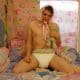 Teen Boy wearing the diaper and also sucking the pacifier