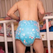 abdl baby in a blue diaper next to a crib